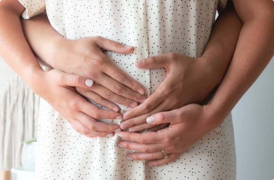 Hands resting on a pregnant belly